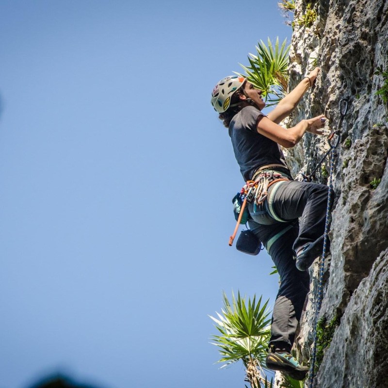 a man flying through the air on a rock