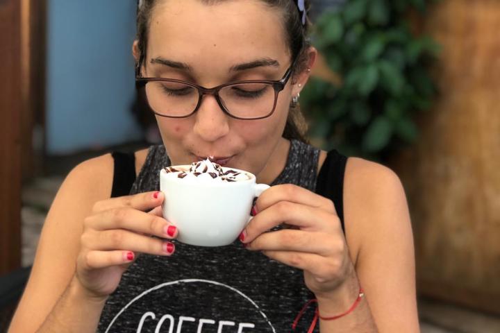 a person holding a cup of coffee