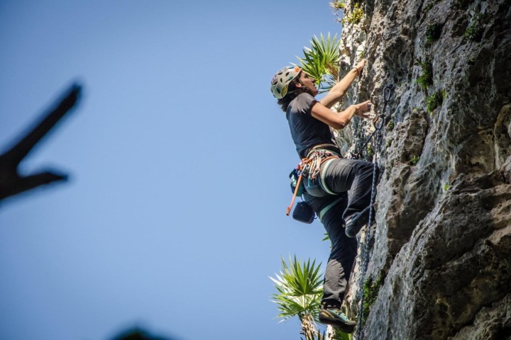 a man flying through the air on a rock